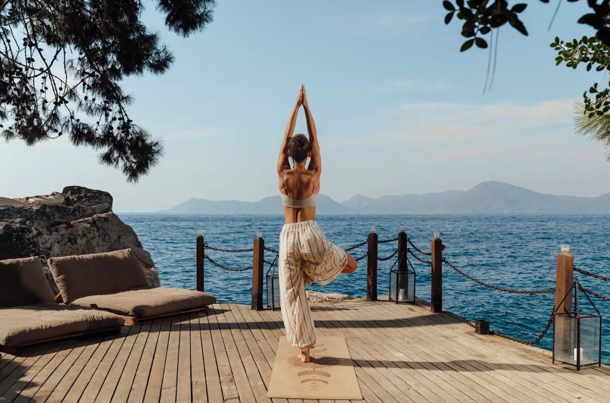 A guest practises yoga on Perdue’s wooden sea deck